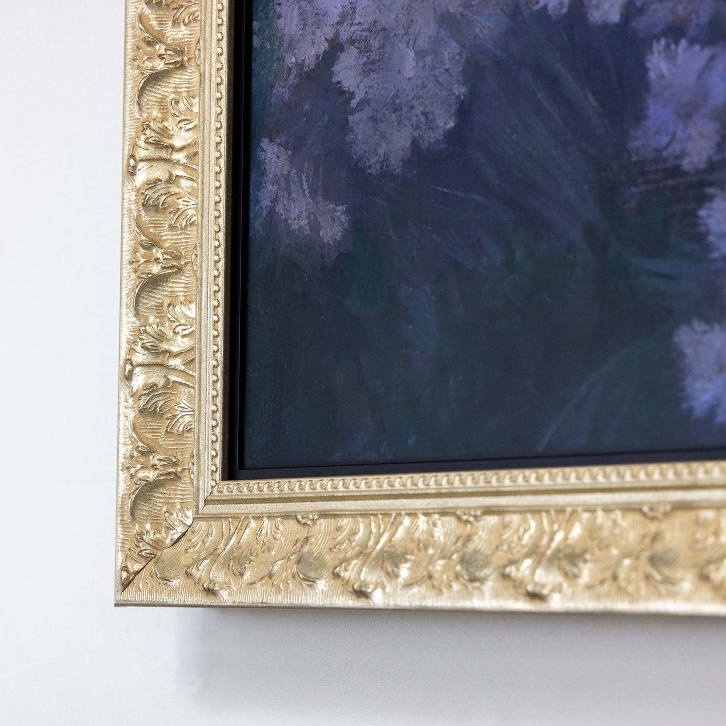 Close up to ornate silver TV Frame corner