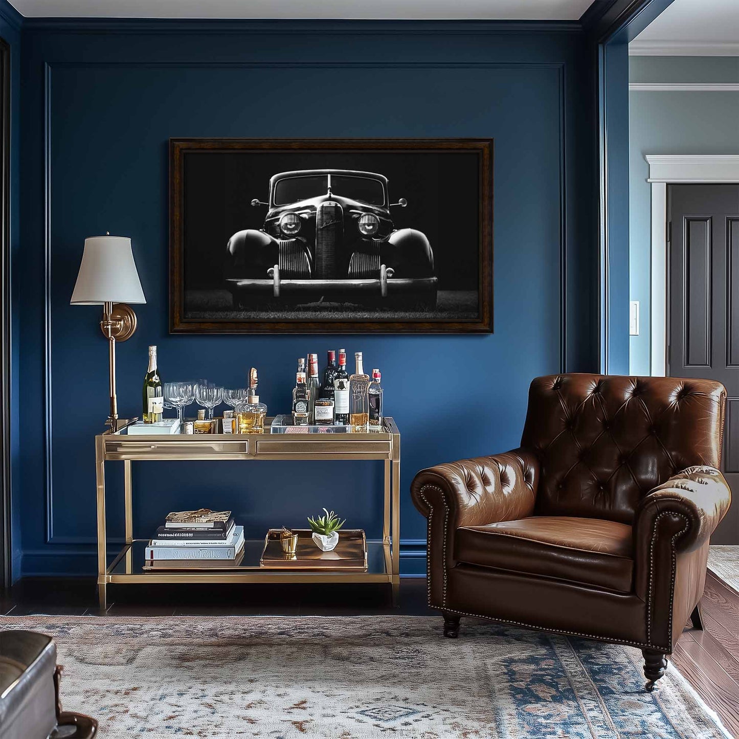 Living room with a brown leather armchair, bar cart, and black and white car art enhancing the dark wood frame tv on a blue wall.