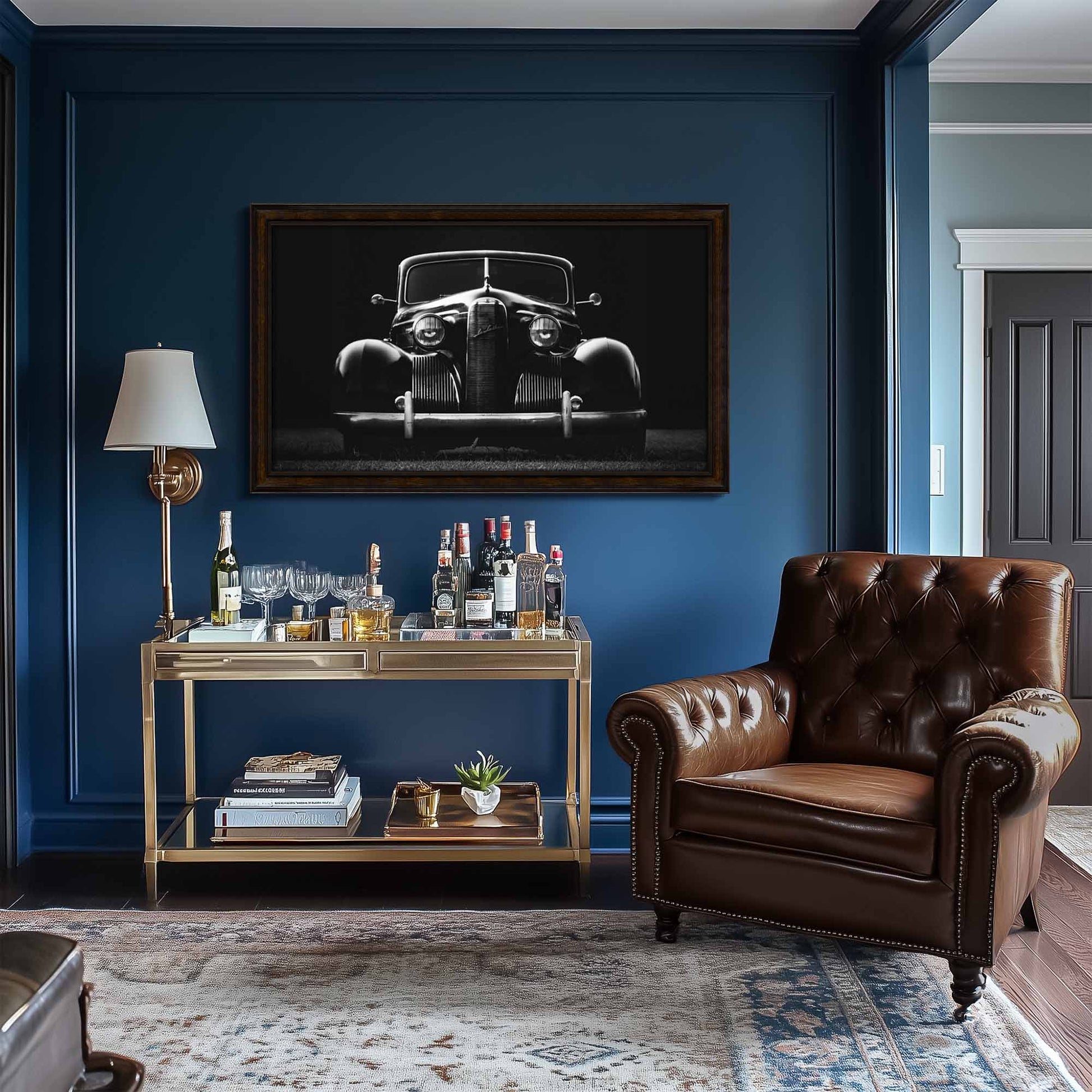 Living room with a brown leather armchair, bar cart, and black and white car art enhancing the dark wood frame tv on a blue wall.