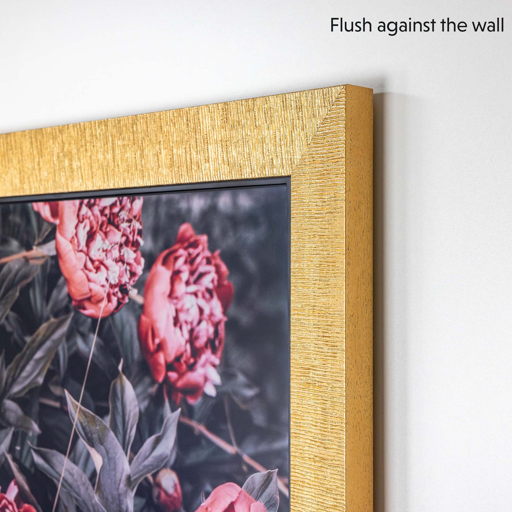 Modern gold tv bezel flushes agains the wall when mounted on the TV