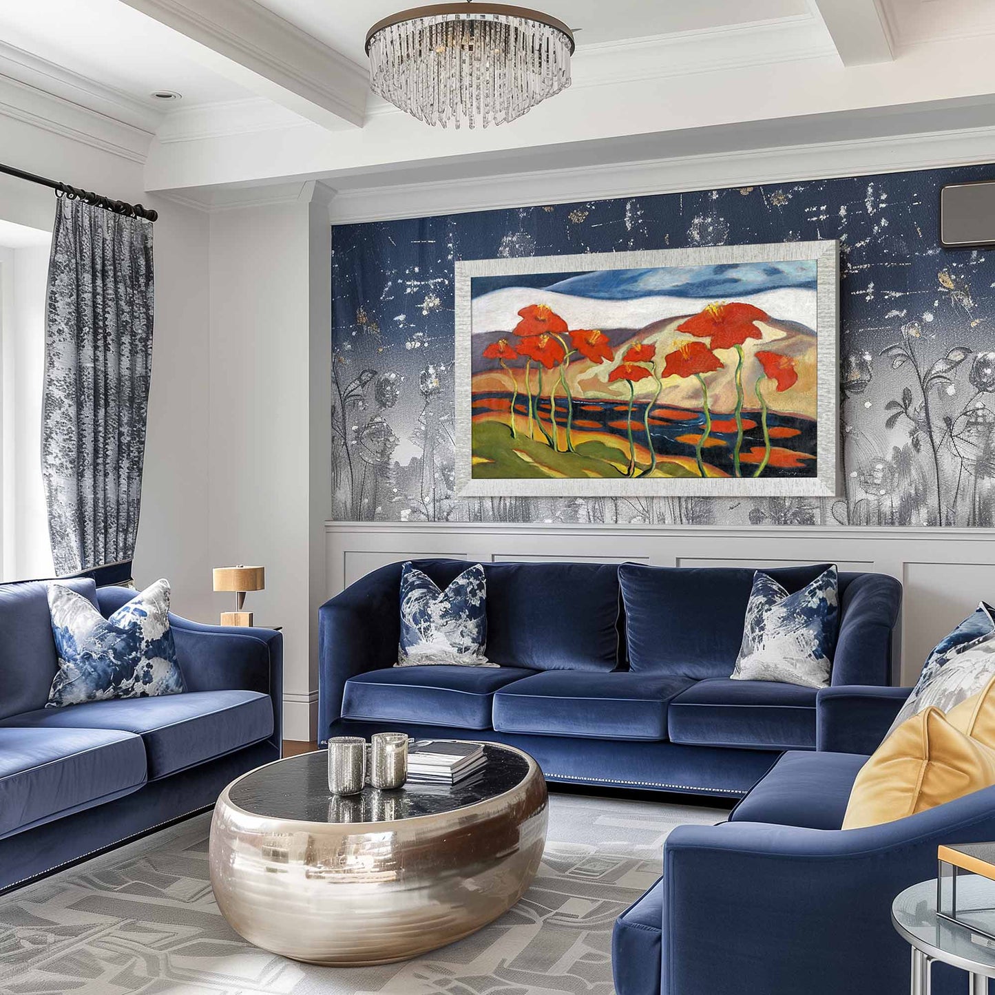 Modern living room with blue sofas, a coffee table, and a painting of red flowers on the wall.