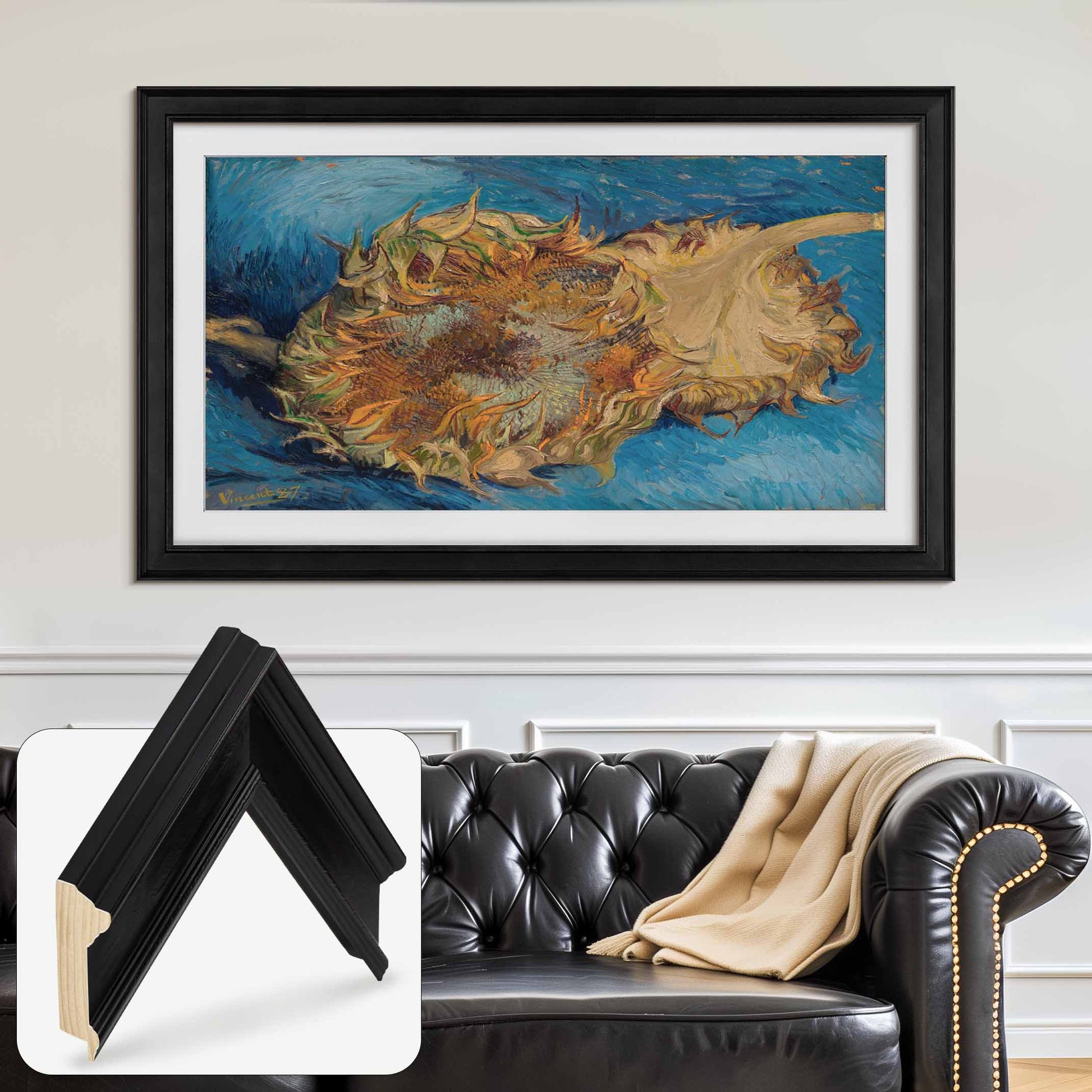 Black handcrafted wooden Samsung TV Frame with sunflower artwork hung above a black leather sofa in modern interior.