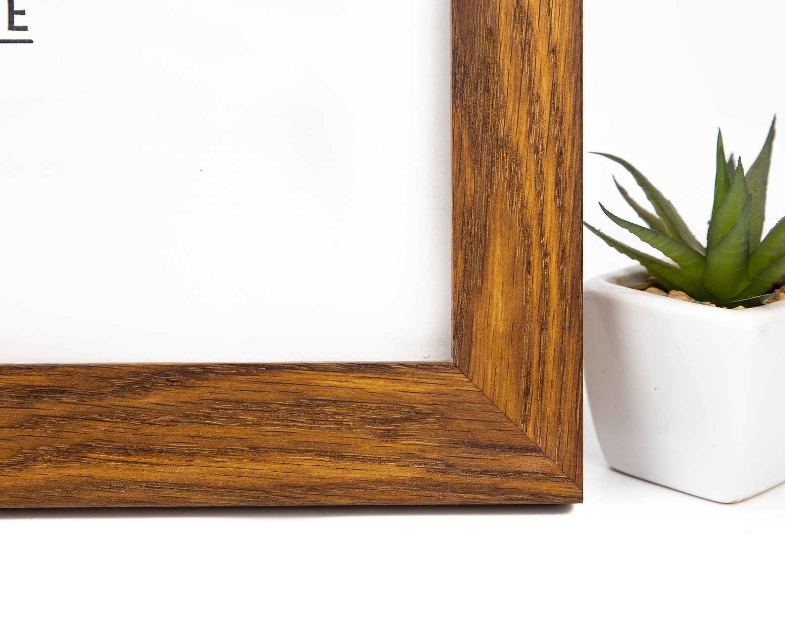 Wooden picture frame corner with a white wall and plant in the background. Oak Wood Photo Frame, Brown Rustic Picture Frame, Any Custom Size Gallery Frame A4, A3, A2, A1, 4x6, 5x7, 8x10, 9x12, 10x14, 16x20, 18x24