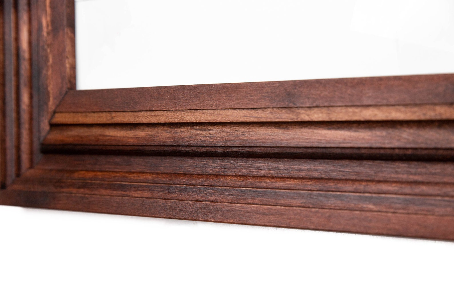 Close-up of a wooden picture frame on a white background