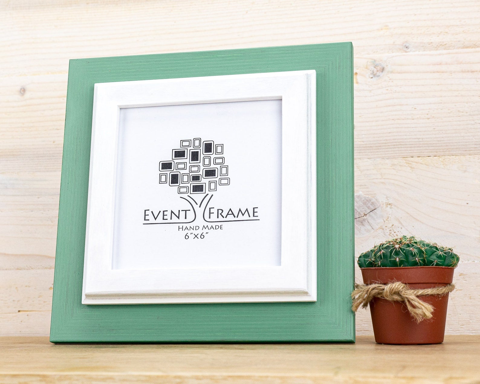Green picture frame with a white mat and 'Event Frame' logo on a wooden surface with a small cactus. Grey and white rustic birch frame with handmade charm and clean contrast. Eco-finished and perfect for art, photos, or calm modern wall décor.
