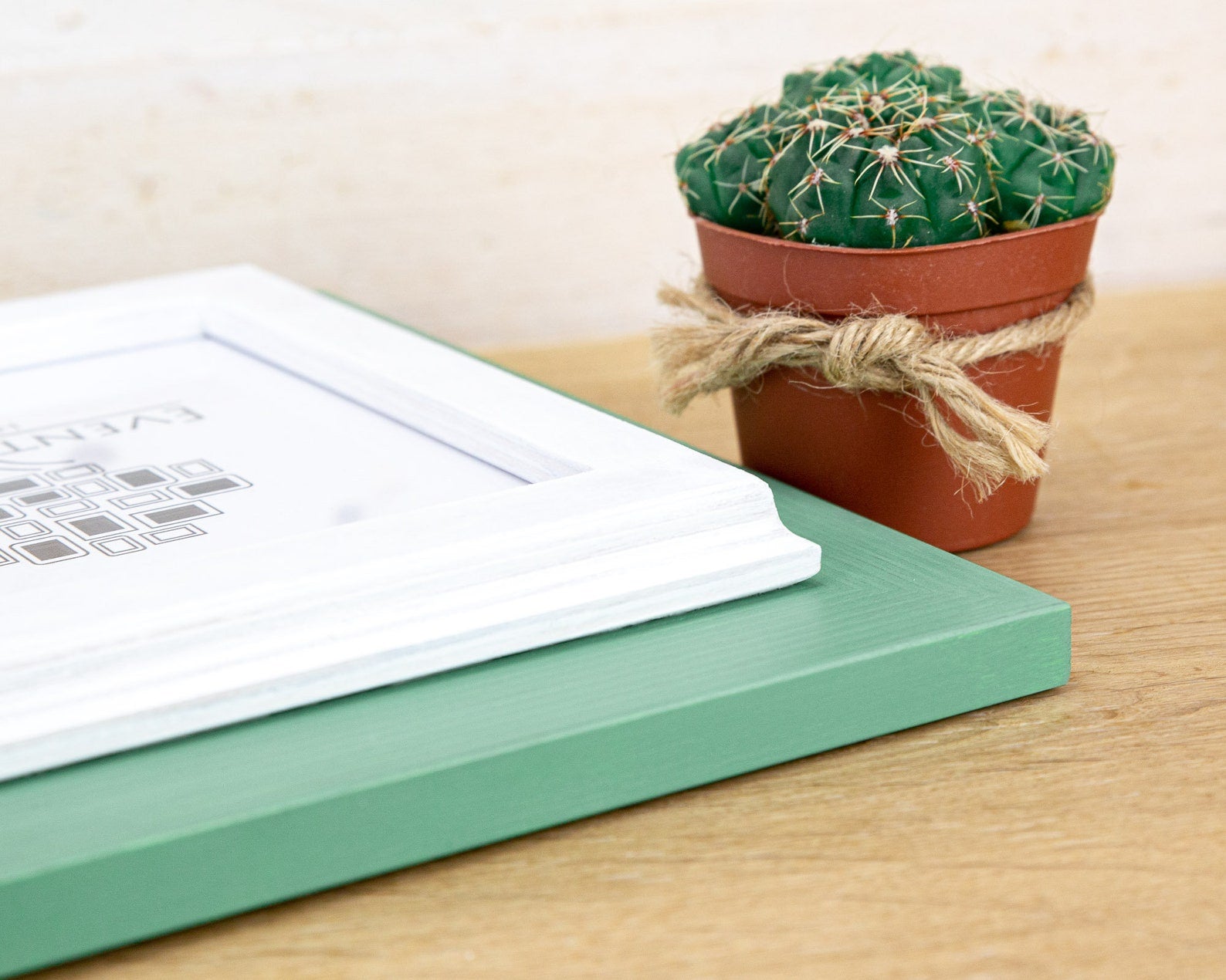 Small potted cactus on a wooden surface next to a green box and white paper. Grey and white rustic birch frame with handmade charm and clean contrast. Eco-finished and perfect for art, photos, or calm modern wall décor.
