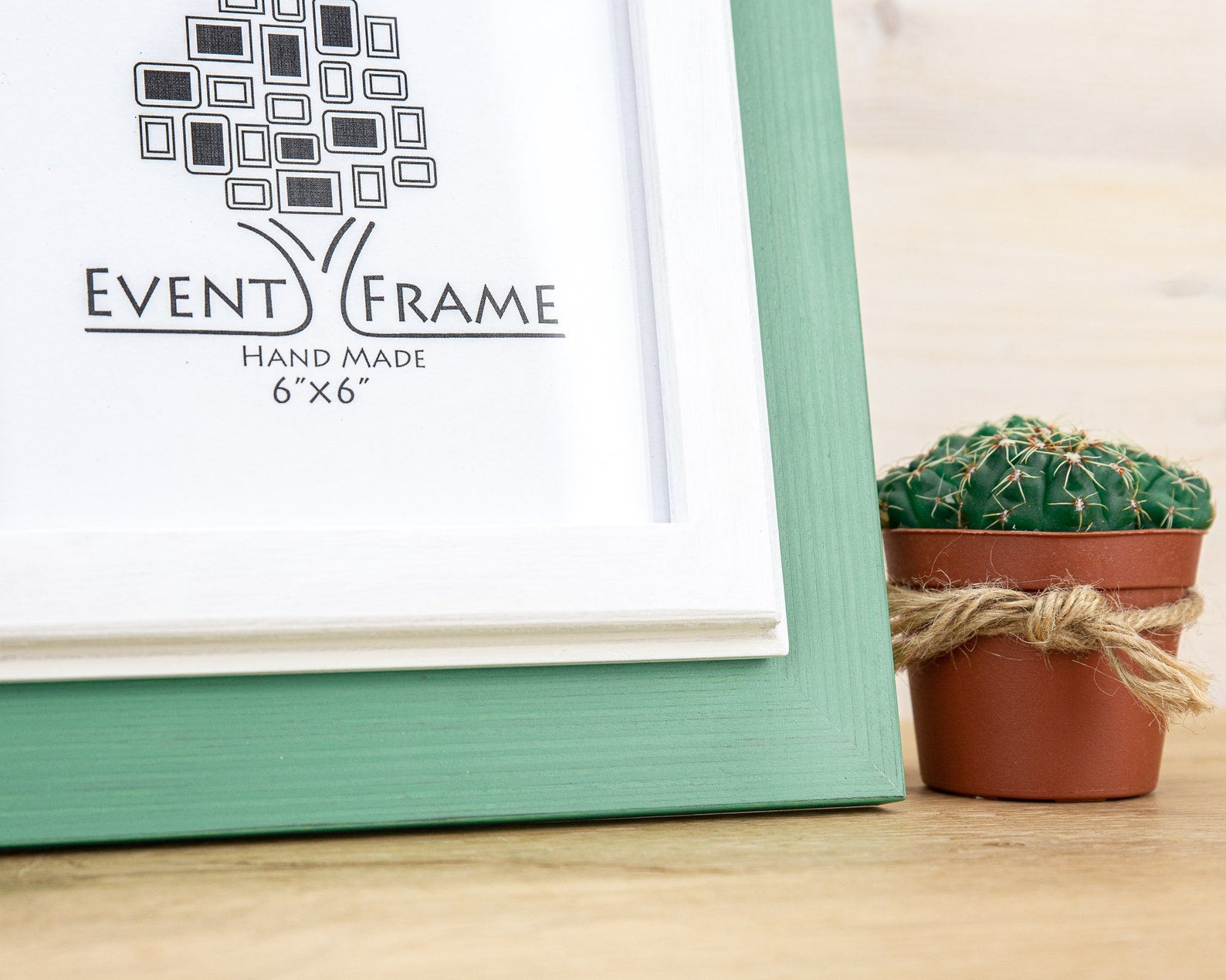 Green picture frame with 'Event Frame' branding on a wooden surface with a cactus plant. Grey and white rustic birch frame with handmade charm and clean contrast. Eco-finished and perfect for art, photos, or calm modern wall décor.