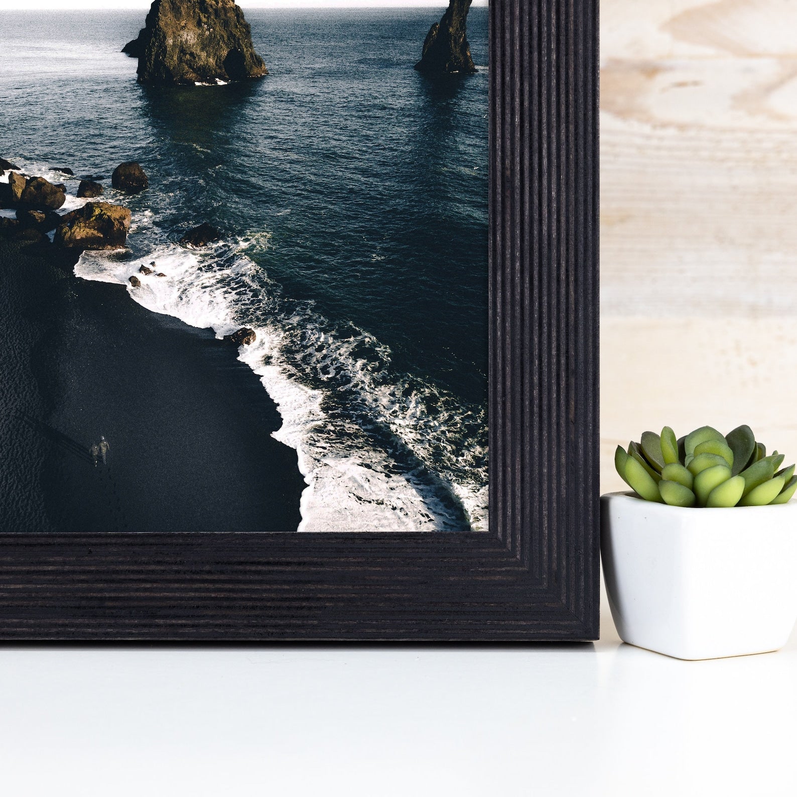 Framed photograph of a coastal scene with waves and rocks, placed next to a potted plant on a light surface. Black Picture Frame, Wooden Photo Frame, Rustic Stripy Design Frame, Dark Academia Decor,Diploma Frame A1 A3 A4 8x10 11x14 12x18 18x24 20x30