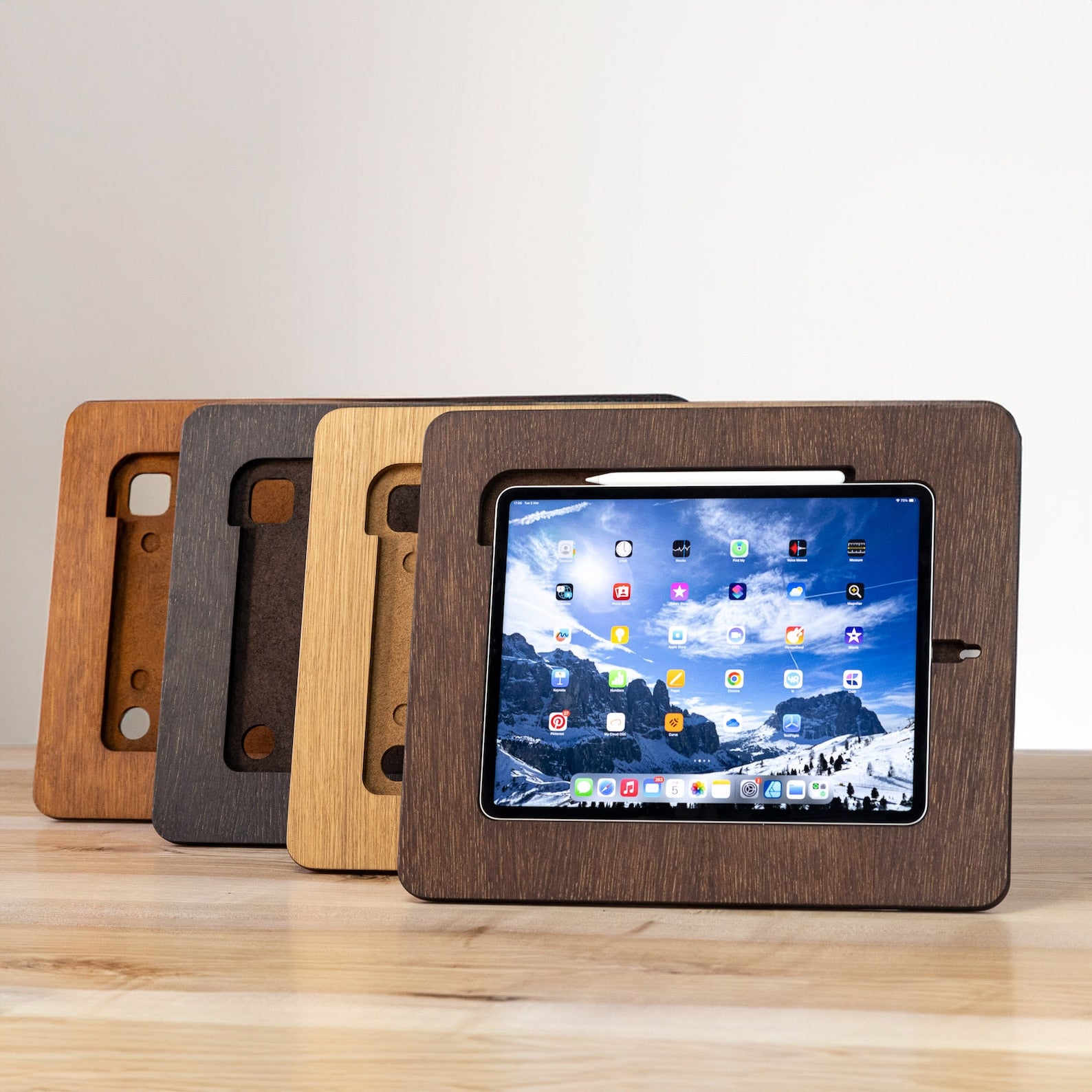 Wooden drawing stand holding an iPad being shown in four different colors- rustic, black, natural and brown.