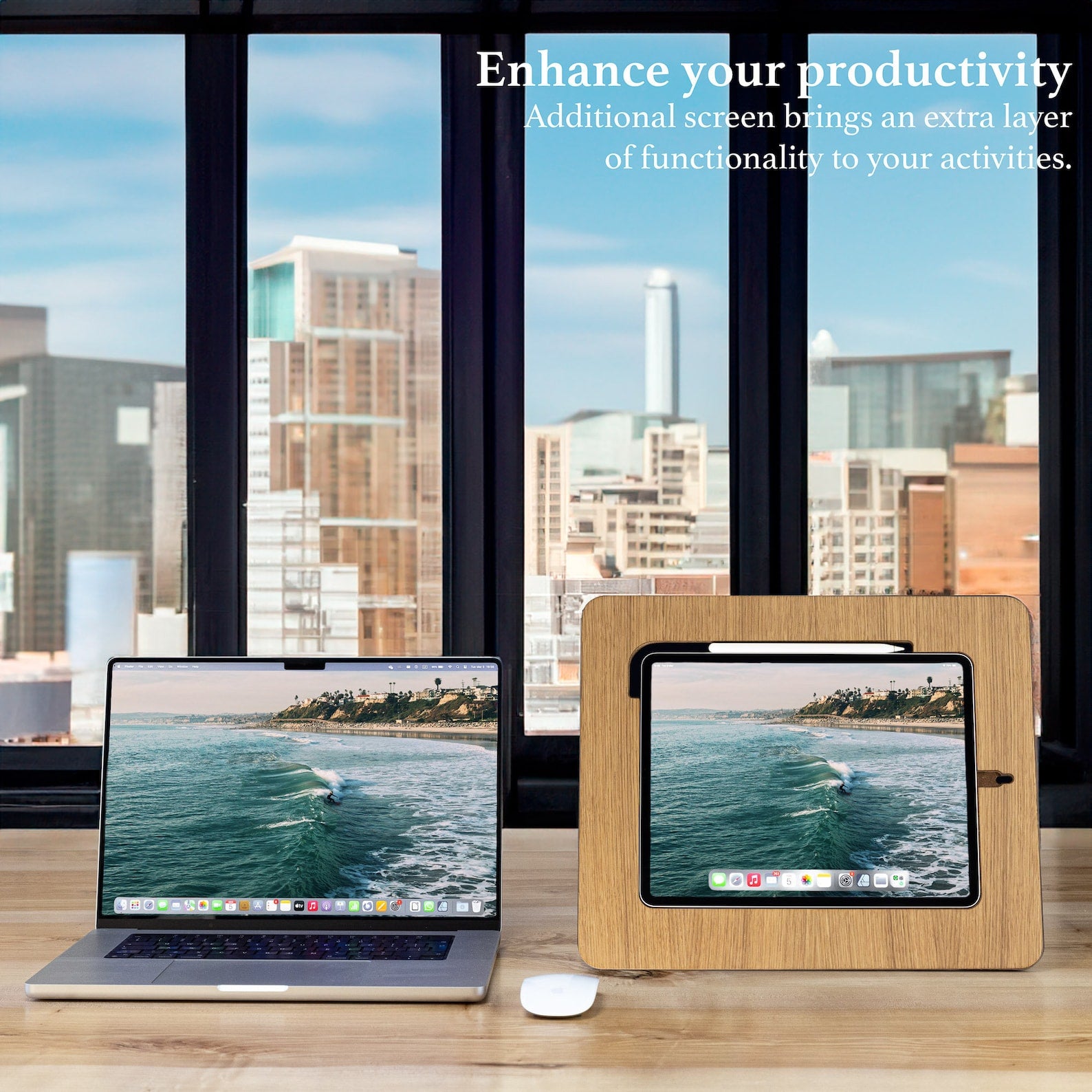 Wooden stand for iPad and Samsung Tab placed next to a laptop in an office studio overlooking a scenic view of the city.