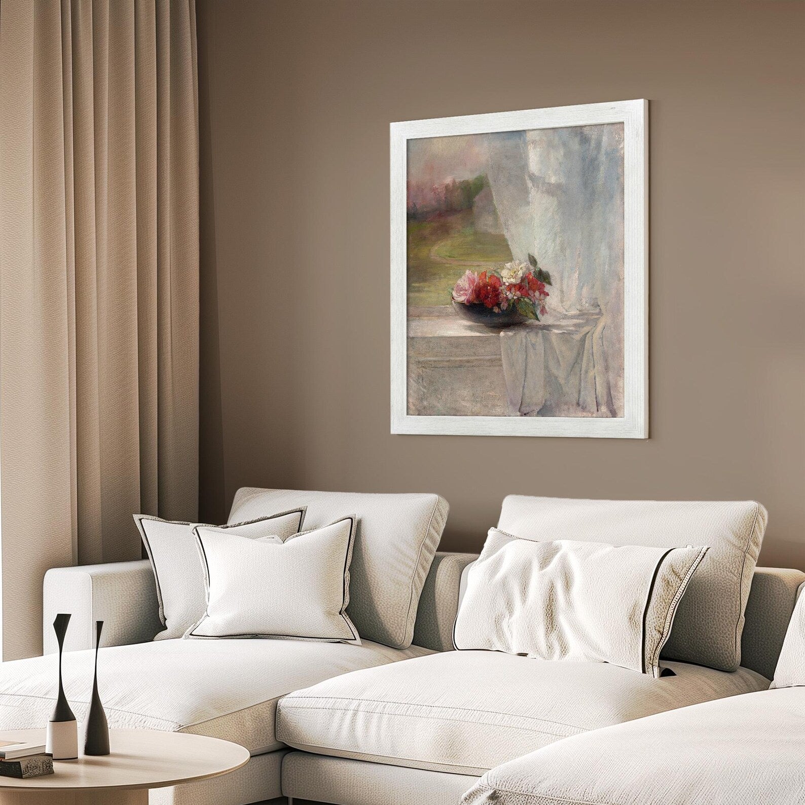 Living room with a beige sofa, decorative pillows, and a framed painting on the wall.