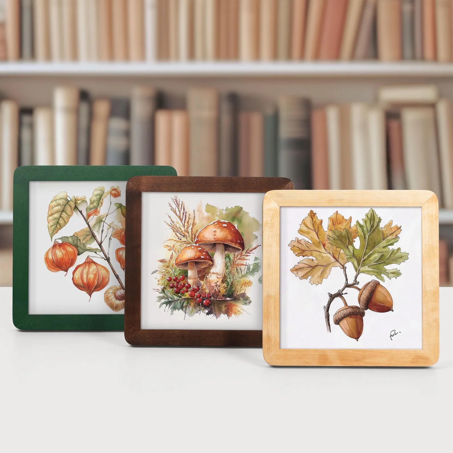 Green brown and beige natural wood picture frames in autumn fall theme in front of a bookcase.