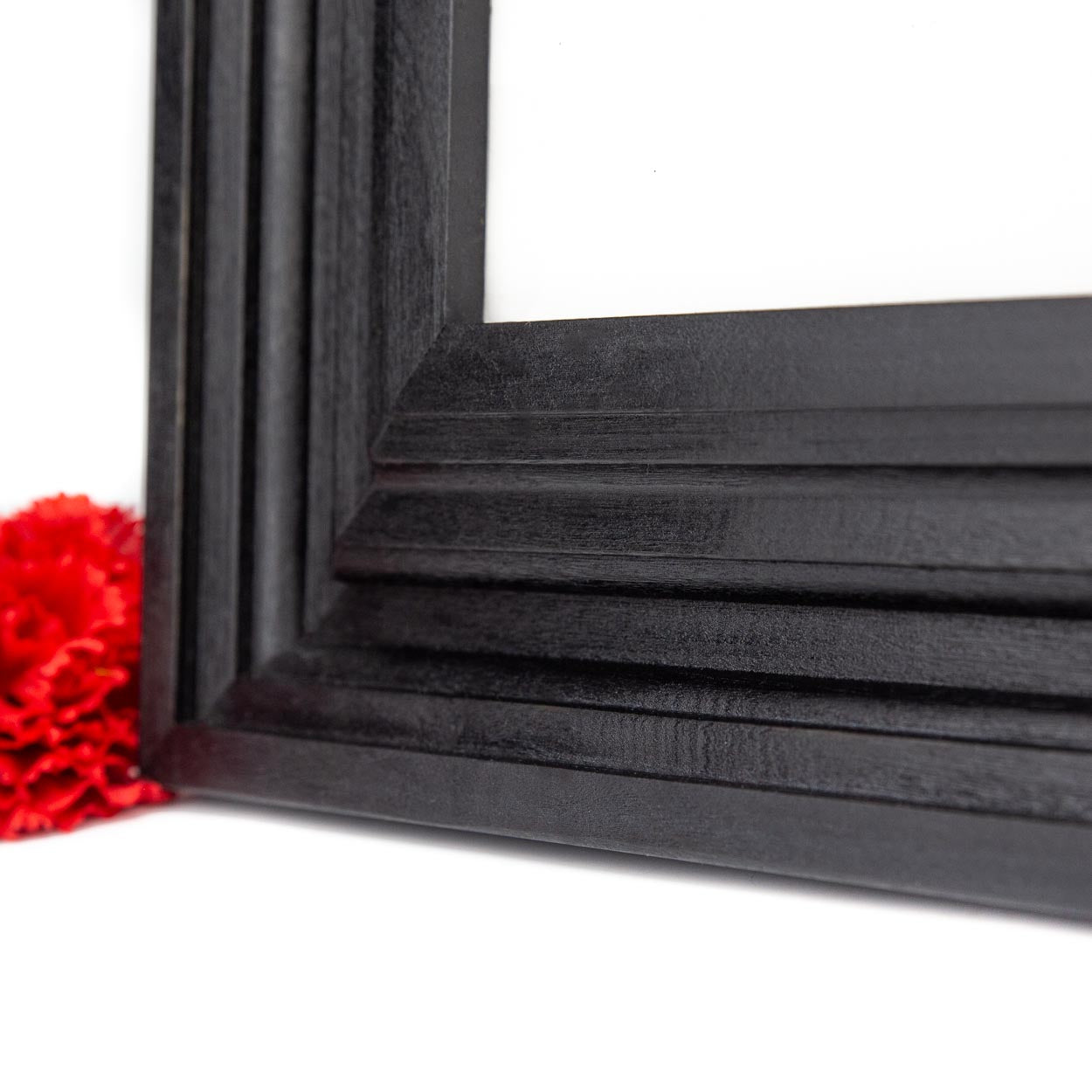 Close up shot of a black empire vintage style solid birch hardwood picture frame.