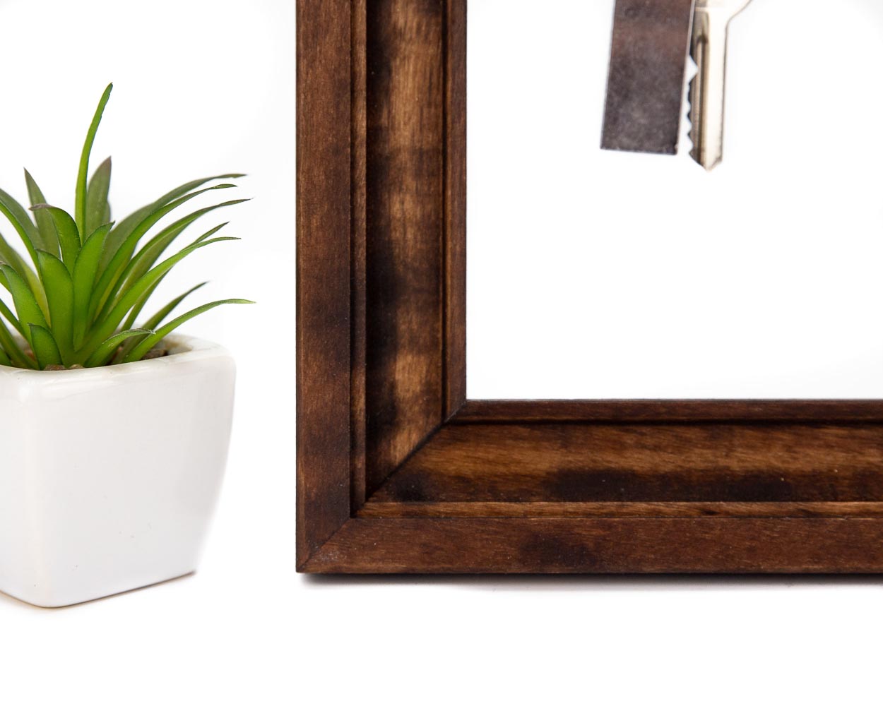 Dark brown wooden key holder frame.