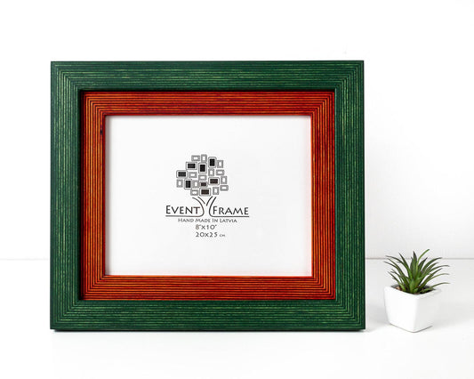 A double green and orange photo frame with a white inner picture, displayed against a neutral background with a small green plant to the side. Green + Orange Picture Frame, Photo Frame with Wooden Mat, Two Tone Gallery Wall Frame, Handmade Poster Frame, Custom Sizes 8x10 24x36 20x30