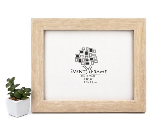 A bleached modern design solid oak hardwood photo frame with a white matte border, labeled 'Event Frame' and capable of holding 5x5 or 8x10 artwork, displayed alongside a small potted plant. Bleached Oak Wood Picture Frame, Shabby Chic Photo Frame, White Wooden Gallery Wall Frame A4, A3, A2, 5x7, 8x10, 11x14, 12x18, 16x20, 18x24