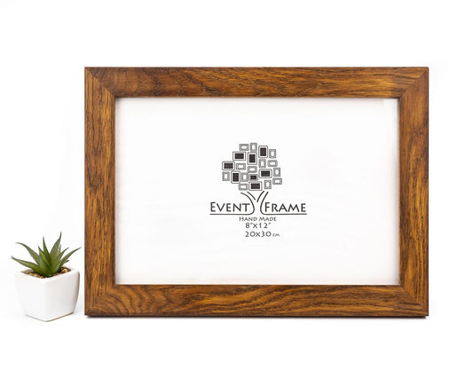 A brown oak hardwood picture frame with a clear acrylic glass cover and the 'EventFrame' brand logo displayed. The frame is set on a white surface with a small potted plant to the side. Oak Wood Photo Frame, Brown Rustic Picture Frame, Any Custom Size Gallery Frame A4, A3, A2, A1, 4x6, 5x7, 8x10, 9x12, 10x14, 16x20, 18x24