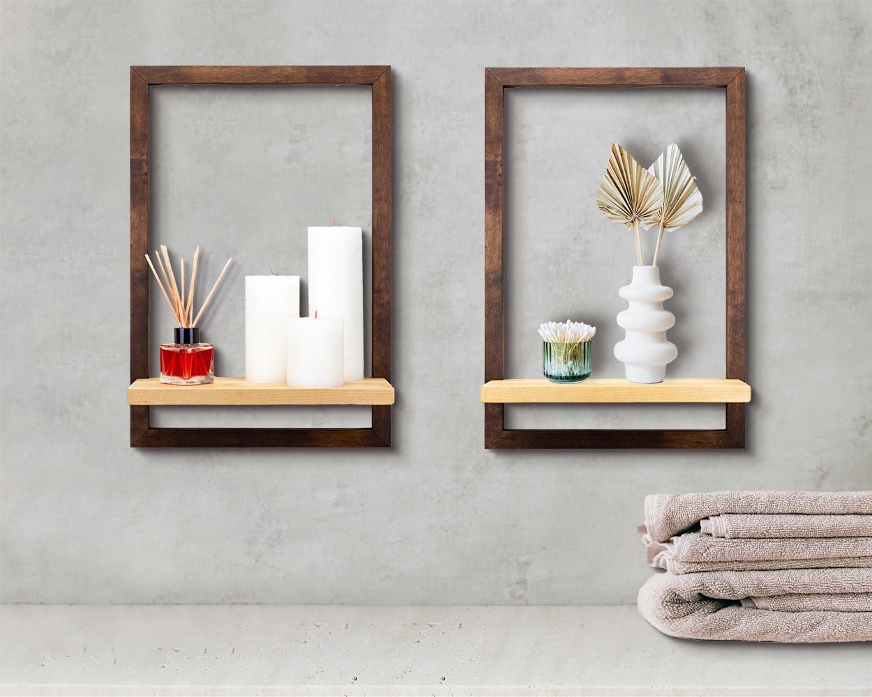 Two dark brown wood framed shelves for bathroom holding home decor.