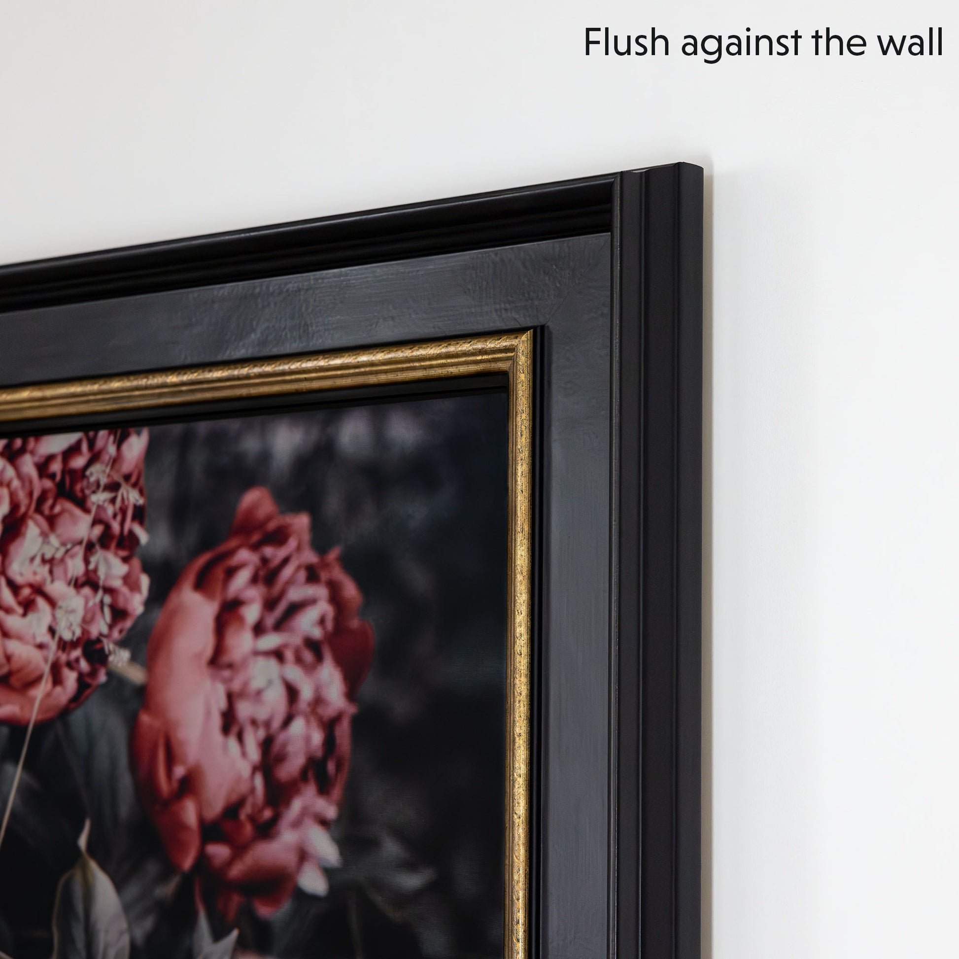Black + gold tv frame mounted on tv flushes against wall