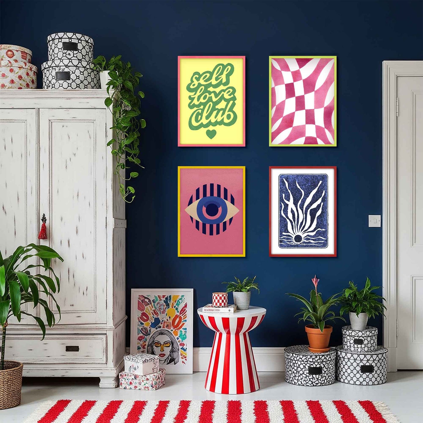 Living room with colorful wall art and decorative items against a blue wall. Shot of colorful wooden picture frames in vibrant colors