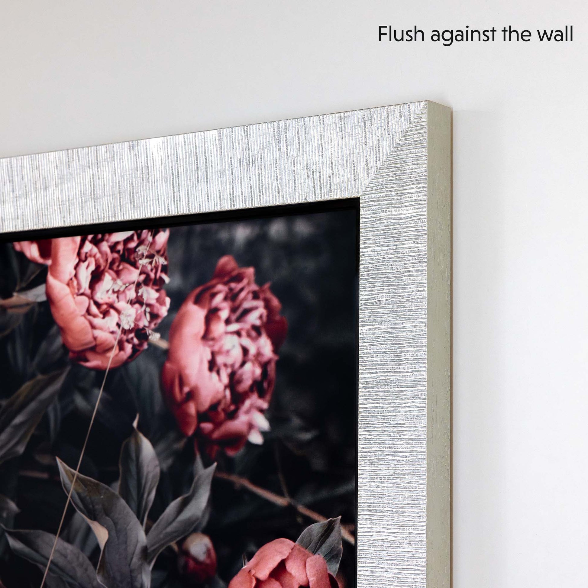 Modern silver tv bezel flushes against the wall when Mounted on TV