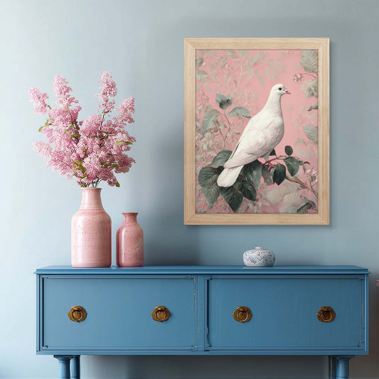 Framed artwork of a white dove on a pink floral background above a blue cabinet with pink vases.