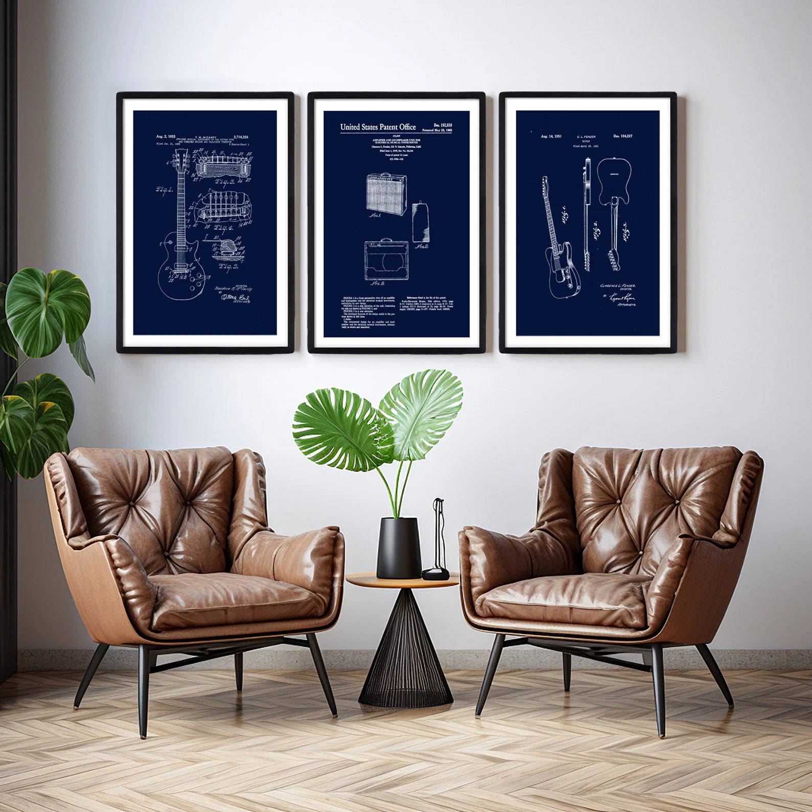 Three black thin wooden picture frames in modern industrial interior with blue plan designs in the frames. 