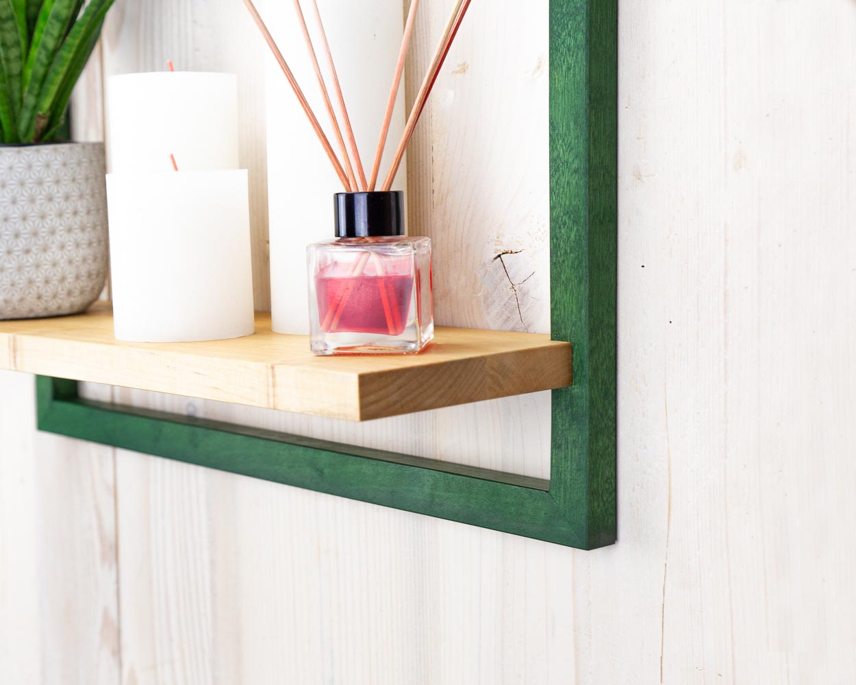 Framed shelf holding plant candles and home decor in custom colors and sizes.