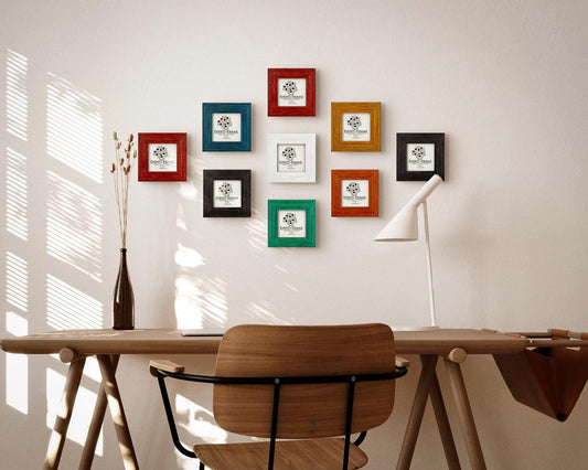 Colorful handmade wooden picture frame set for square photos above a desk in natural home office environment. 